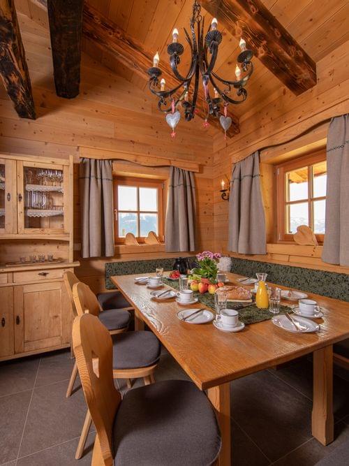 Cozy alpine dining room with wooden decor set for breakfast