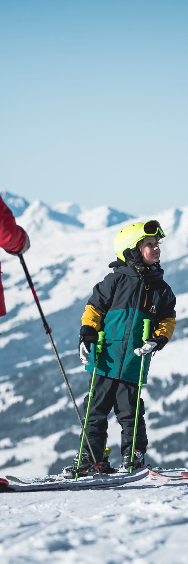 A family with a child skiing on the mountain.
