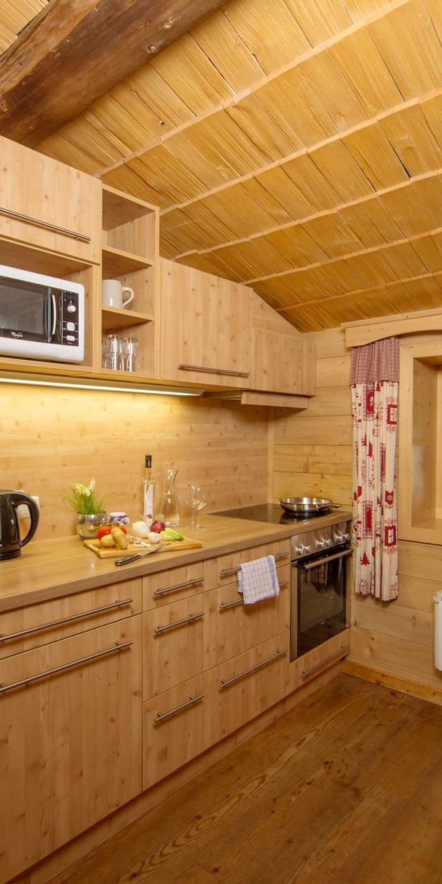 Cozy wooden kitchen with modern appliances and rustic cabin decor