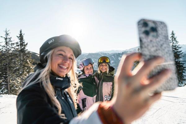 4 Frauen in Skibekleidung am Berg machen ein Selfie von sich