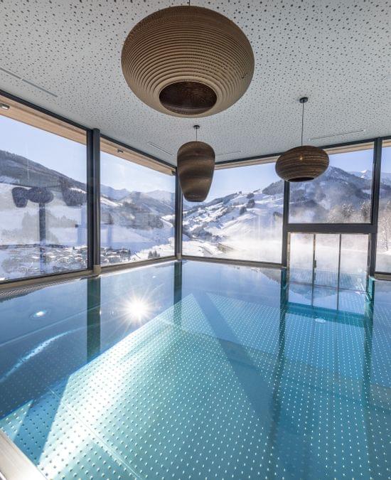Bachgut Badehaus Innenbecken mit Ausblick auf die Winterlandschaft 