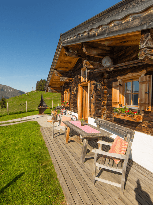 The Bachalm in summer, surrounded by green alpine meadows and mountains.