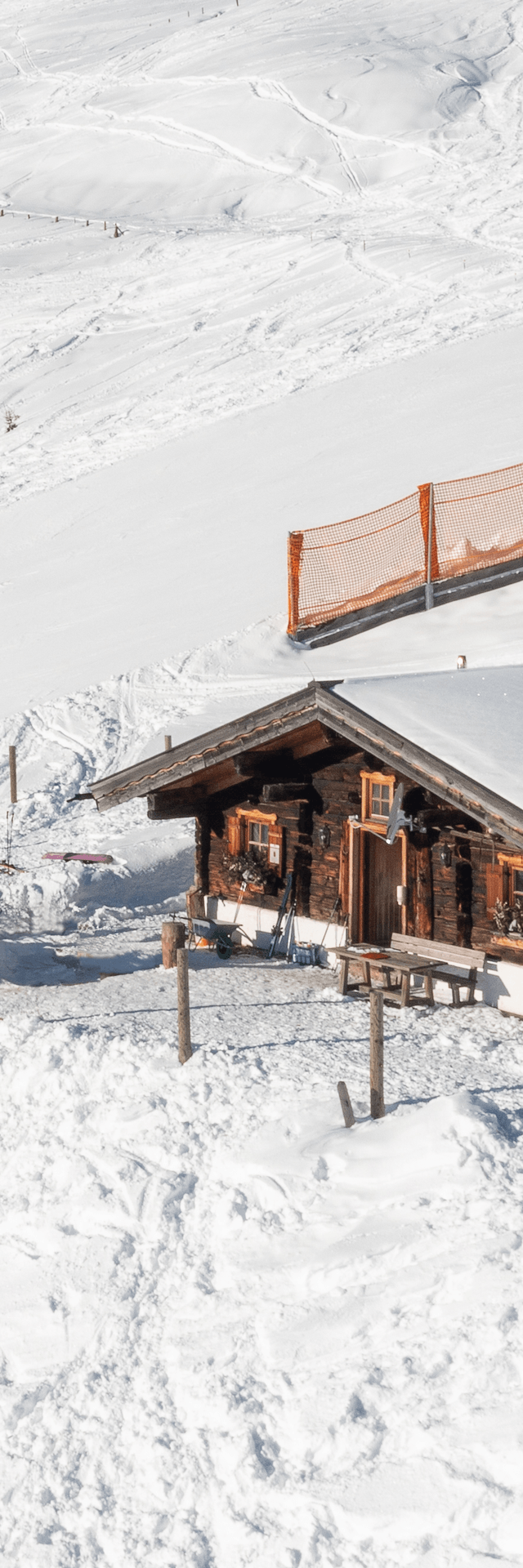 The Bachalm exterior in winter, deeply snow-covered with bright sunshine.