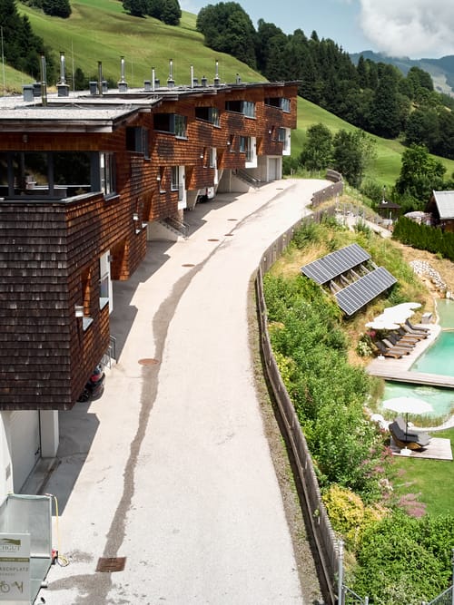 A bird’s-eye view of Bachgut in summer, surrounded by meadows and lush greenery.