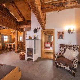 Cozy alpine chalet interior with wood beams, rustic furniture and traditional decor