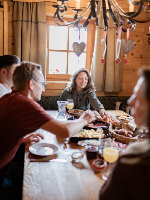 Four people eating at a set table.