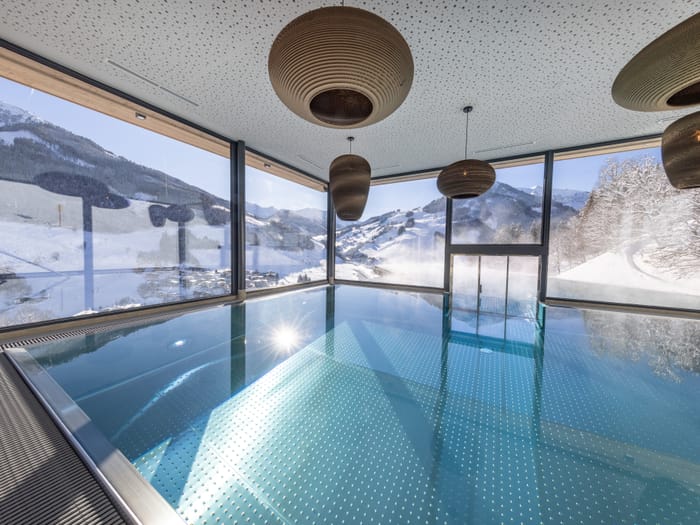 The Bachgut bathhouse indoor pool with a view of the winter landscape.