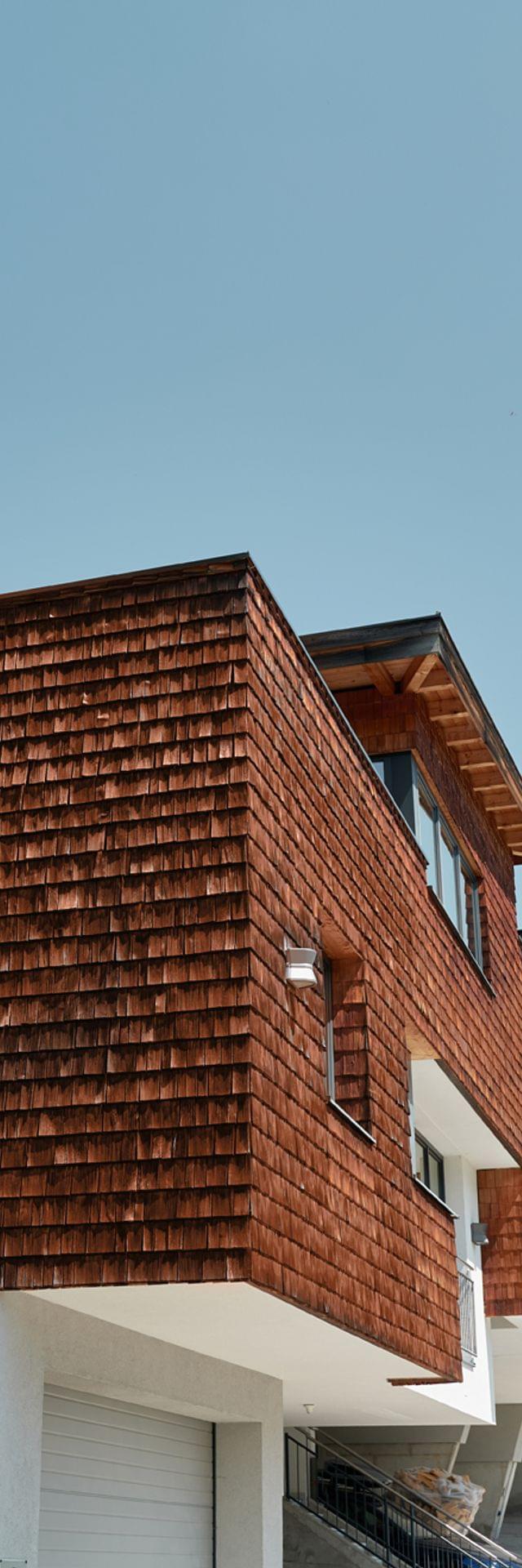 Bachgut mountain resort with wooden facade and scenic hillside location under clear blue sky