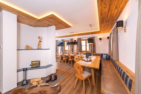 Cozy alpine dining room with wood furniture, fireplace and ambient lighting